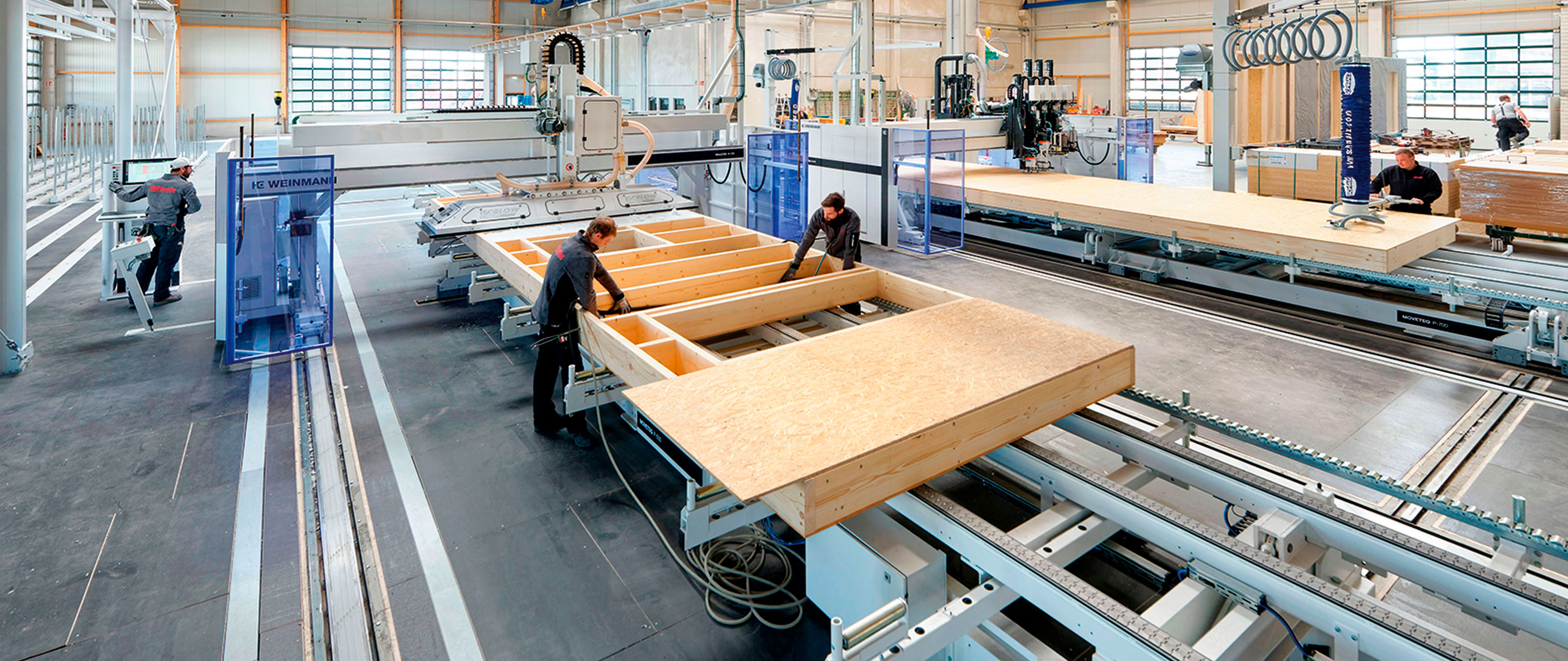 Linea di produzione per pareti in legno per case prefabbricate WEINMANN con ponte chiodatrice e tavoli di montaggio