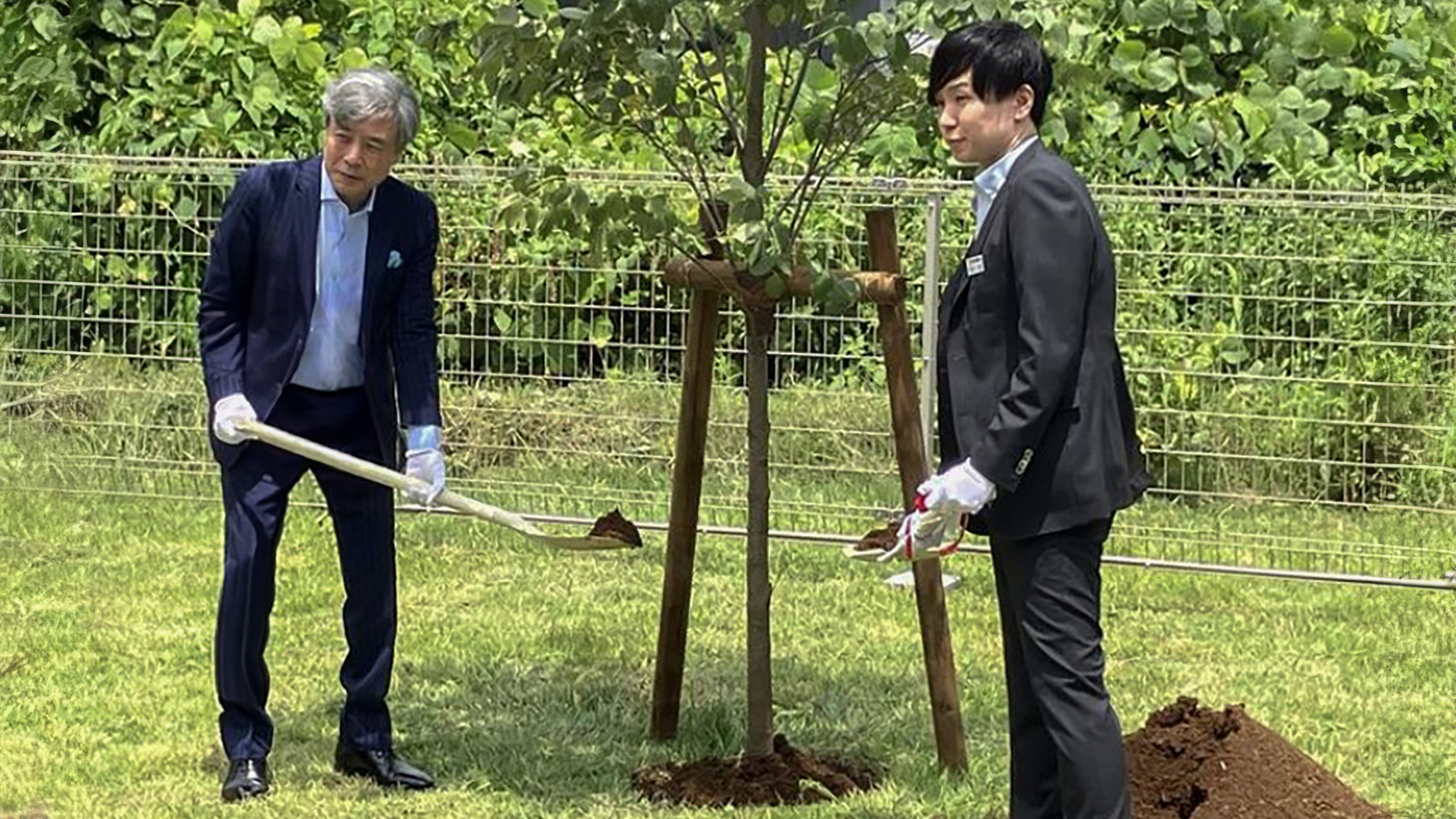 Managing director and factory owner planting a tree by the new factory in the opening ceremony.  