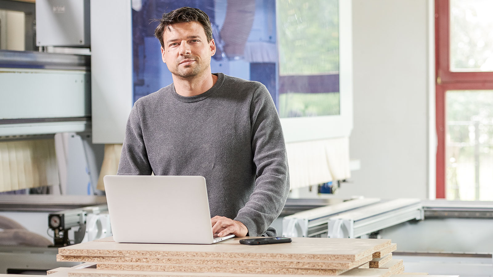 Löw Breidenbach Joinery, Owner Benjamin Löw in front of his CNC